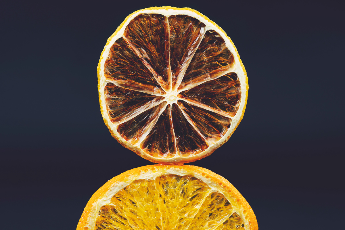 Dry slices of citrus fruits on a black background. Space for text.